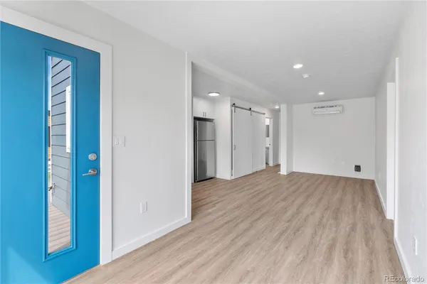 a view of empty room with wooden floor and closet