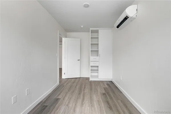 a view of walk in closet with wooden floor