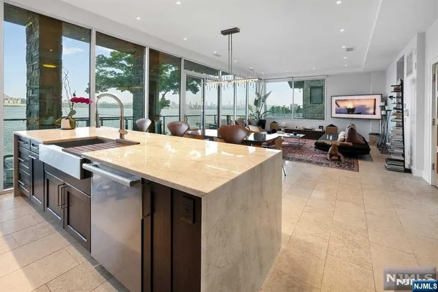 a living room with fireplace furniture and a large window