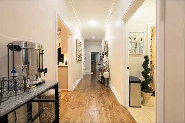 a large kitchen with stainless steel appliances kitchen island granite countertop a large counter top and view of living room