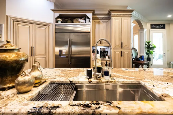 a bathroom with a granite countertop sink and a mirror