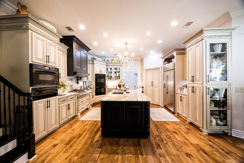 595 Grey Rock Drive Midland, GA 31820 - Photo 24 of 95 a large kitchen with stainless steel appliances kitchen island granite countertop a large counter top and view of living room