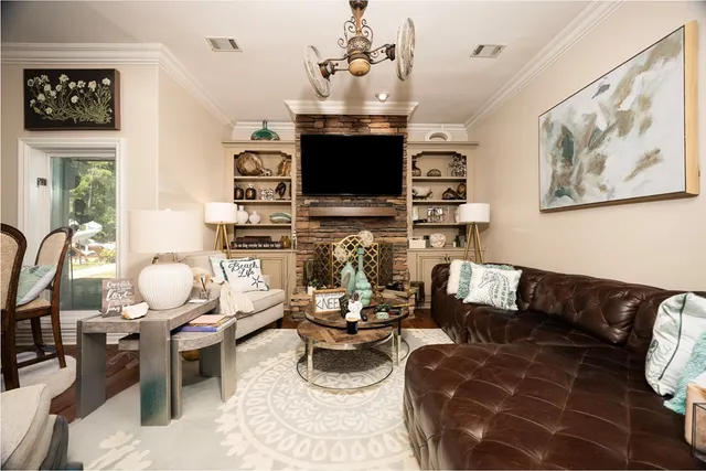 a bedroom with a bed dresser and a large window