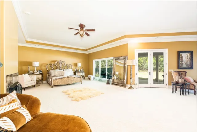 a spacious bedroom with a bed and a chandelier