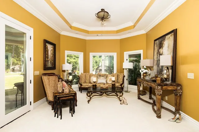 a view of a dining room with furniture and a kitchen view
