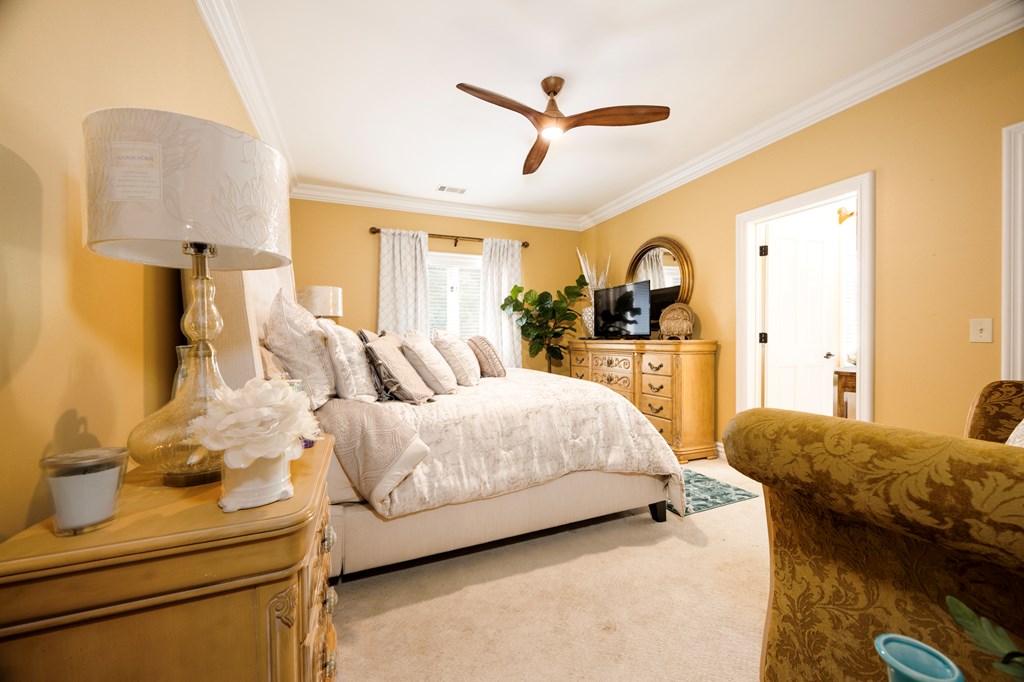 595 Grey Rock Drive Midland, GA 31820 - Photo 59 of 95 a bedroom with a bed and a chandelier