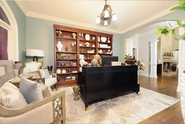 a living room with fireplace furniture and a large window