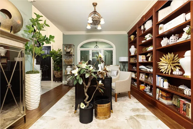 a living room with fireplace furniture and a chandelier
