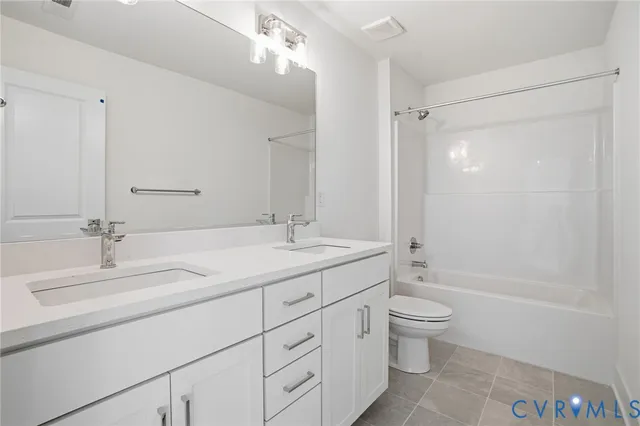 a bathroom with a double vanity sink toilet mirror and shower