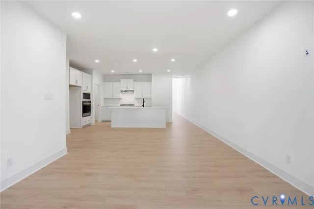 a view of a kitchen with a sink and a refrigerator