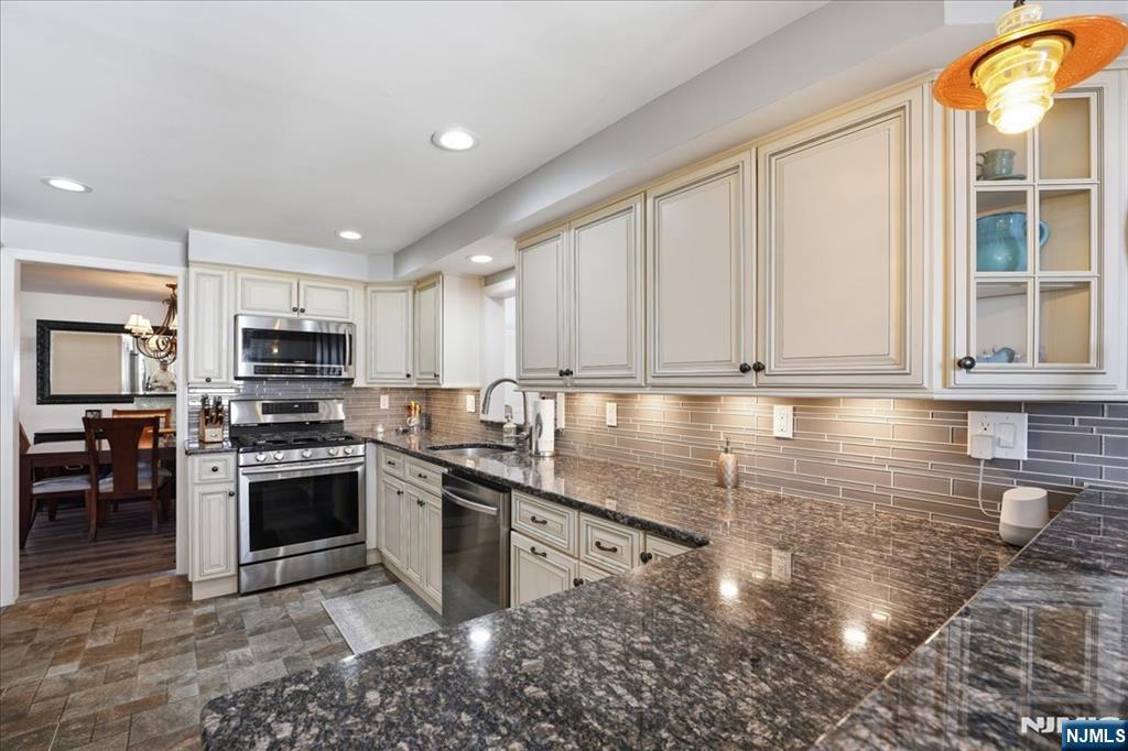 72 West Saddle River Road Waldwick, NJ 07463 - Photo 14 of 50 a kitchen with stainless steel appliances granite countertop a stove a sink and a microwave
