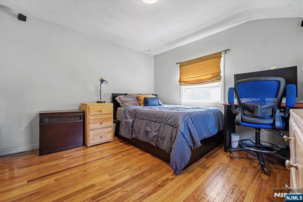 72 West Saddle River Road Waldwick, NJ 07463 - Photo 31 of 50 a bedroom with a bed and wooden floor