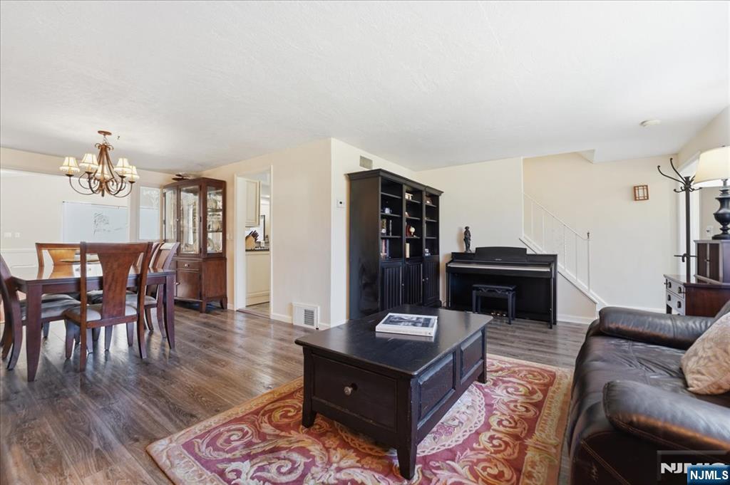 72 West Saddle River Road Waldwick, NJ 07463 - Photo 8 of 50 a living room with furniture a dining table and wooden floor