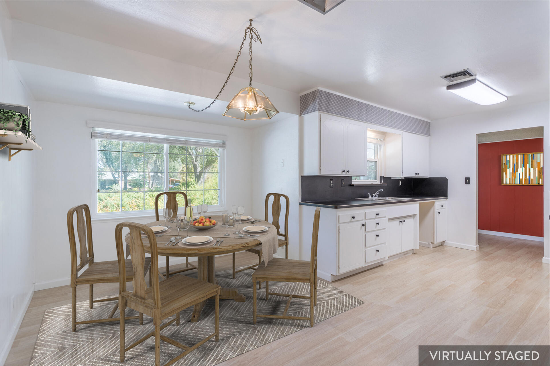 8850 Redbank Road Redding, CA 96001 - Photo 8 of 18 a kitchen with a dining table chairs and white cabinets