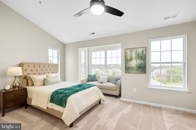 a bedroom with a large bed and a couch