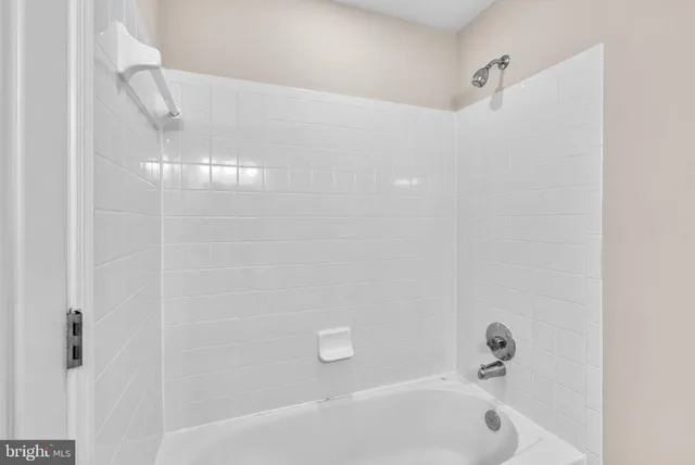 a bathroom with a bathtub and shower