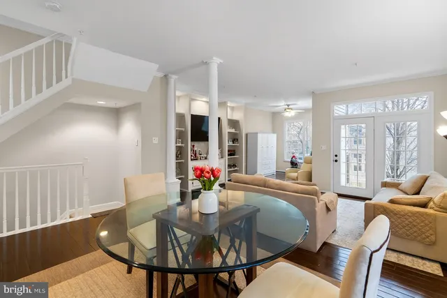 a dining room with furniture and wooden floor