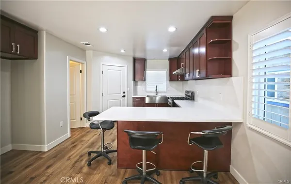 a kitchen with a table chairs refrigerator and microwave