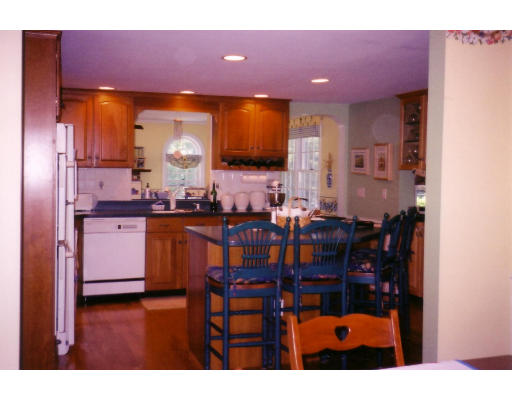 41 Elmcrest Road Wakefield, MA 01880 - Photo 3 of 5 a kitchen with stainless steel appliances kitchen island granite countertop a dining table chairs cabinets and a sink