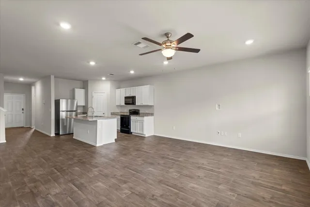 a view of a kitchen with a sink and microwave