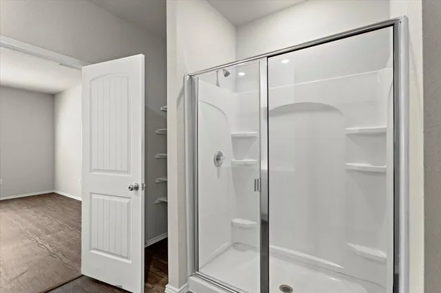 a bathroom with a glass shower door