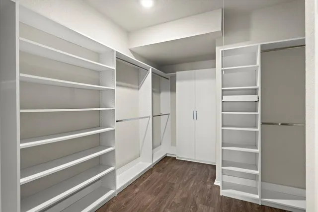 a view of walk in closet with empty racks