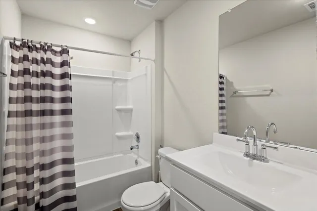 a bathroom with a sink toilet a shower and a mirror