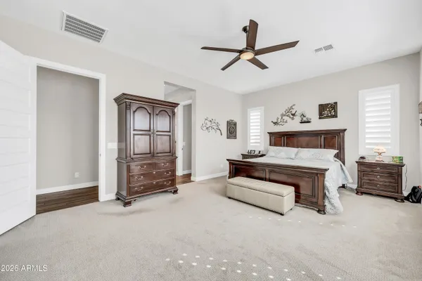 a living room with furniture and a ceiling fan