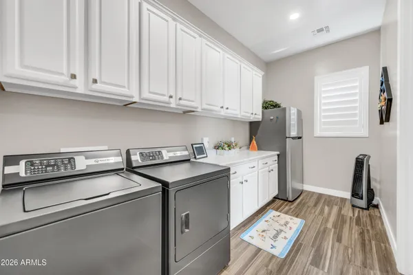 a kitchen with granite countertop a sink stainless steel appliances and cabinets