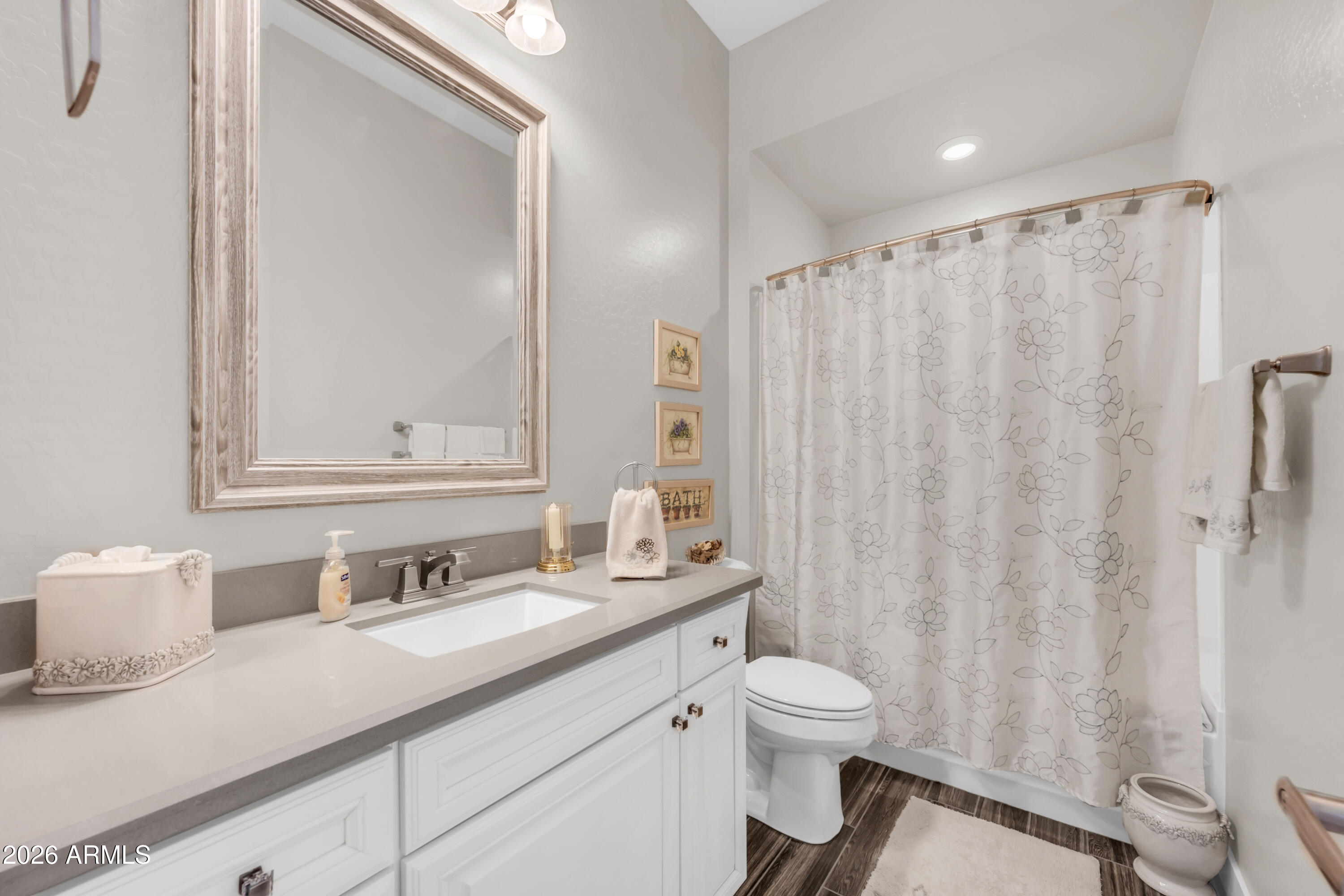 1867 East Gillcrest Road Gilbert, AZ 85298 - Photo 25 of 48 a bathroom with a granite countertop sink a toilet and a mirror