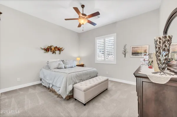 a spacious bedroom with a bed and a table in it