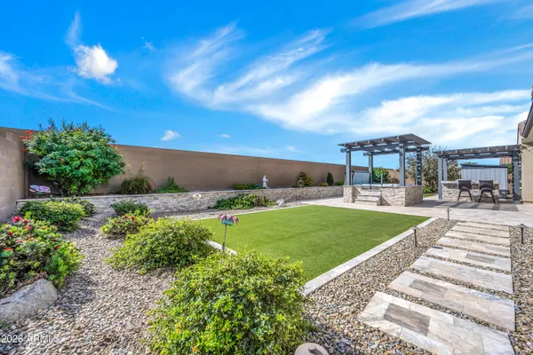 a view of a garden with a building in the background