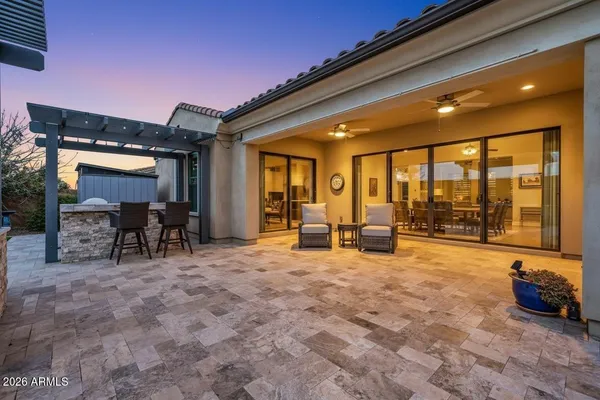a living room with furniture and large windows