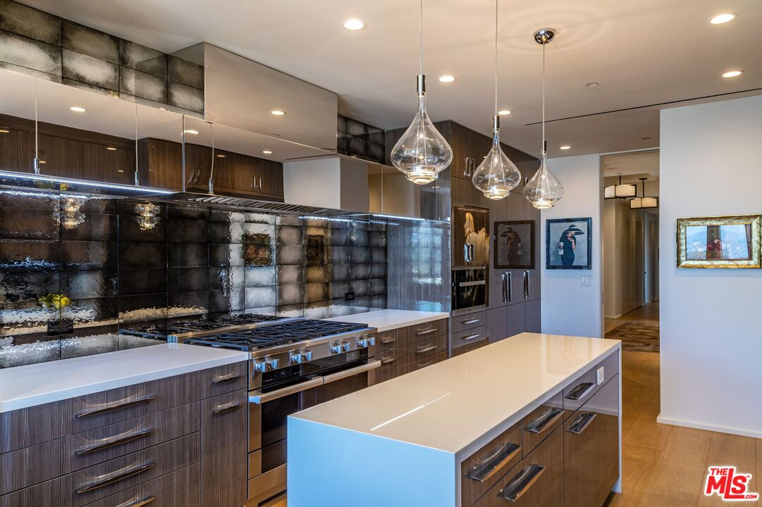 10601 Wilshire Boulevard, Unit 19E Los Angeles, CA 90024 - Photo 18 of 38 a kitchen with a stove and a wooden floor