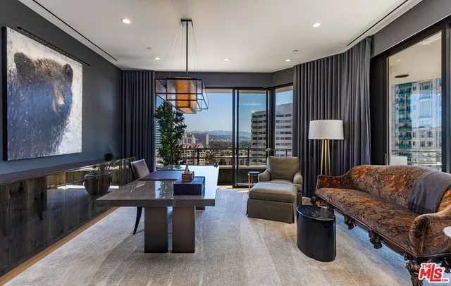 a bedroom with furniture and large windows