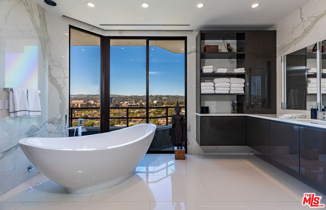 10601 Wilshire Boulevard, Unit 19E Los Angeles, CA 90024 - Photo 28 of 38 a living room with a large window and furniture