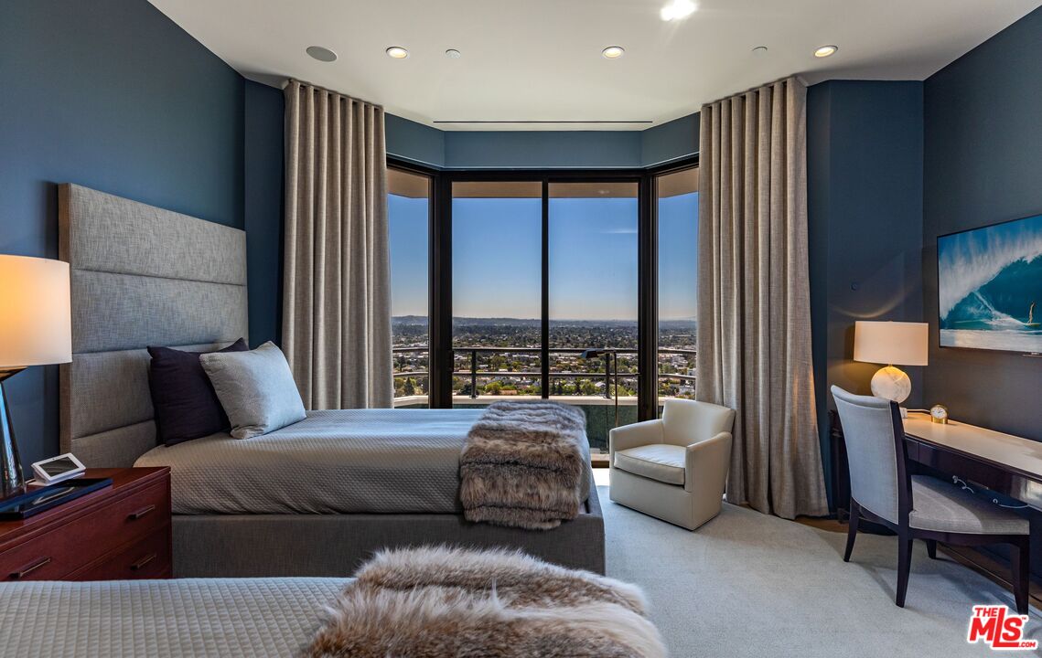 10601 Wilshire Boulevard, Unit 19E Los Angeles, CA 90024 - Photo 31 of 38 a bedroom with a bed and glass window