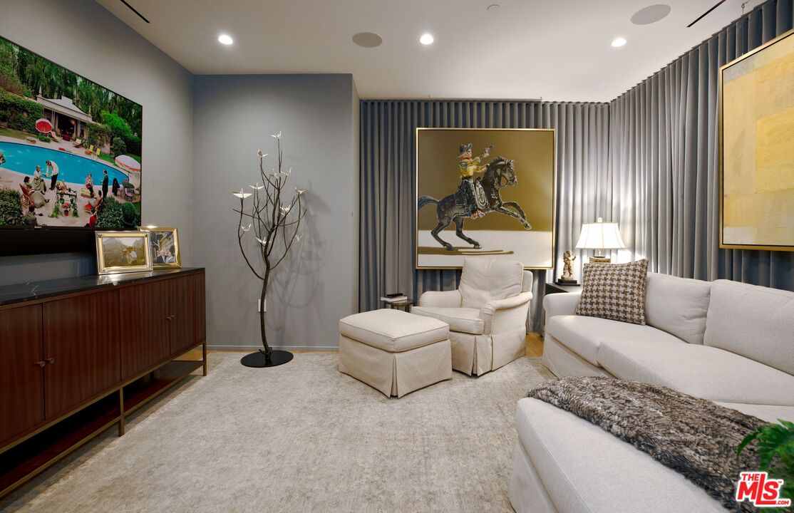 10601 Wilshire Boulevard, Unit 19E Los Angeles, CA 90024 - Photo 35 of 38 a living room with furniture and a flat screen tv