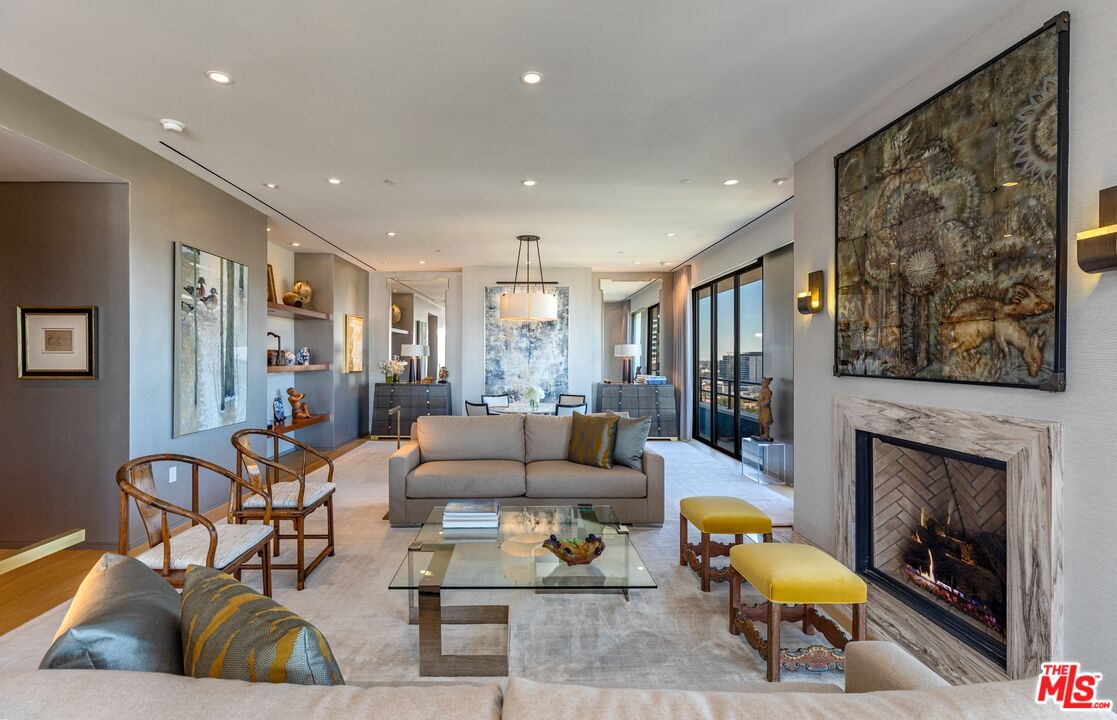10601 Wilshire Boulevard, Unit 19E Los Angeles, CA 90024 - Photo 7 of 38 a living room with furniture and a fireplace