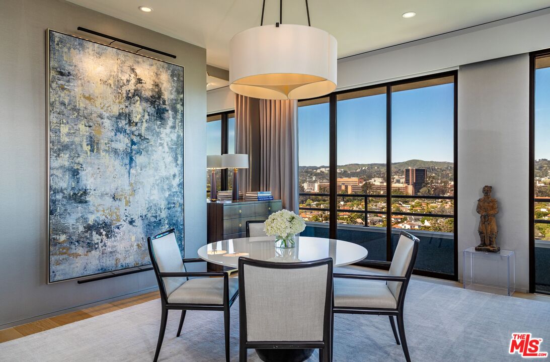 10601 Wilshire Boulevard, Unit 19E Los Angeles, CA 90024 - Photo 9 of 38 a dining room with furniture and a large window