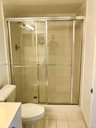 a bathroom with a shower and a toilet