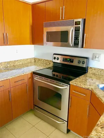 a kitchen with a stove top oven and sink