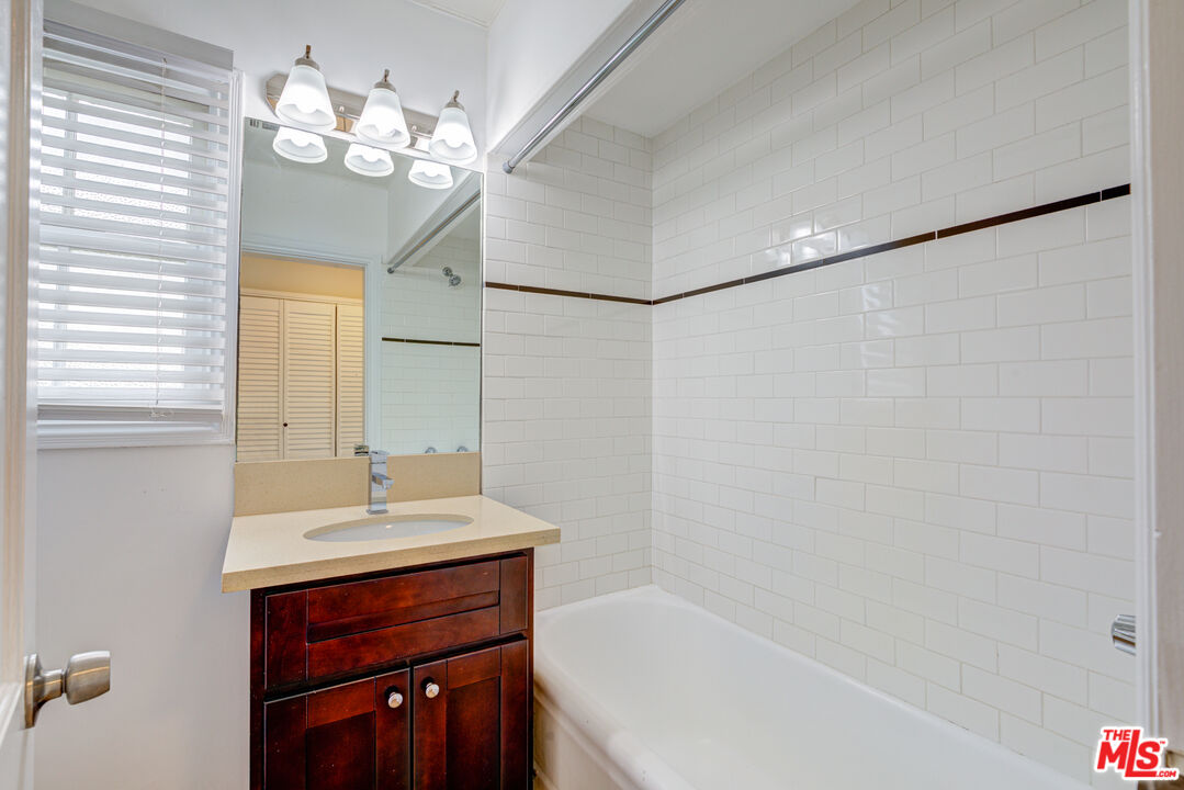 9643 Charleville Boulevard Beverly Hills, CA 90212 - Photo 13 of 21 a bathroom with a sink double vanity mirror and a bathtub