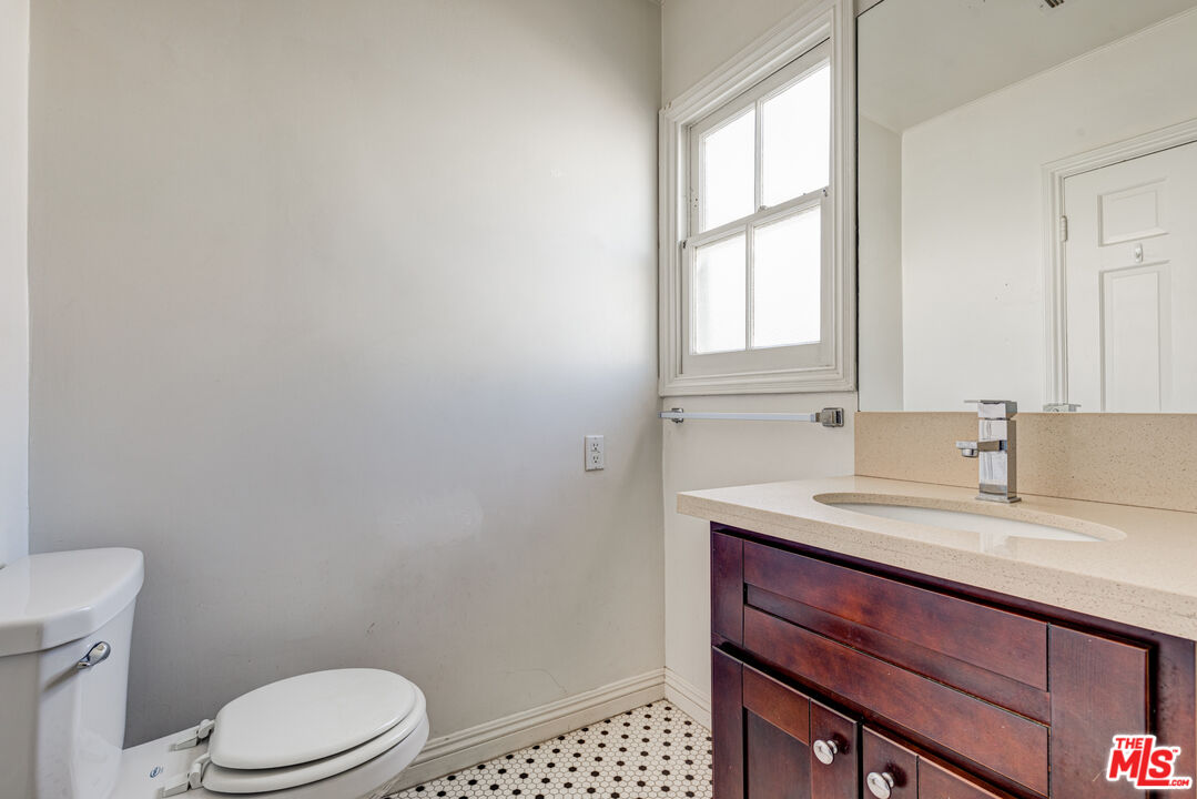 9643 Charleville Boulevard Beverly Hills, CA 90212 - Photo 14 of 21 a bathroom with a sink a toilet and a window