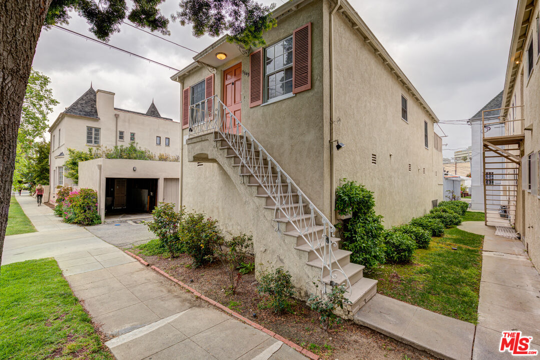 9643 Charleville Boulevard Beverly Hills, CA 90212 - Photo 19 of 21 a front view of a house with a garden