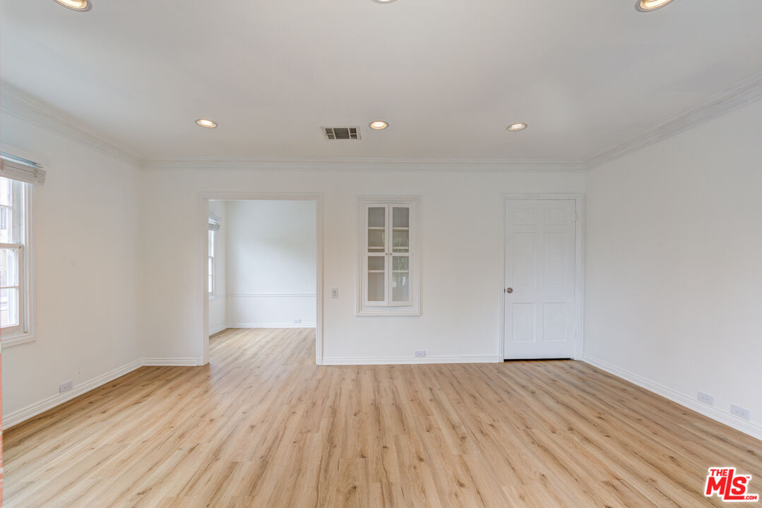 9643 Charleville Boulevard Beverly Hills, CA 90212 - Photo 2 of 21 a view of empty room with wooden floor and fan