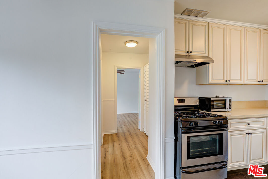 9643 Charleville Boulevard Beverly Hills, CA 90212 - Photo 6 of 21 a kitchen with a stove and a microwave