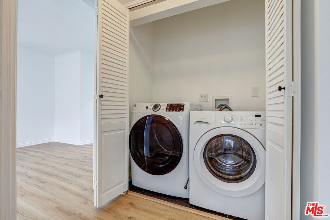 9643 Charleville Boulevard Beverly Hills, CA 90212 - Photo 8 of 21 a utility room with dryer and washer
