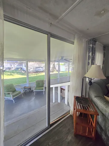 a living room with furniture and a floor to ceiling window