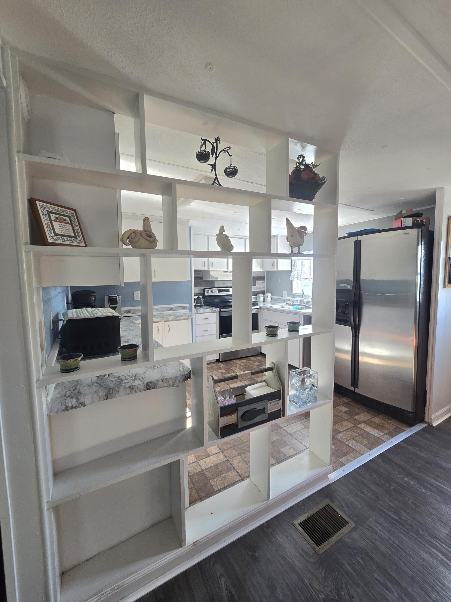 2612 Southeast 29th Street Okeechobee, FL 34974 - Photo 19 of 46 a kitchen with stainless steel appliances kitchen island granite countertop a refrigerator stove and sink
